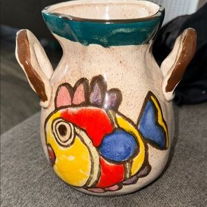 This is a vintage hand-painted ceramic pitcher 1976